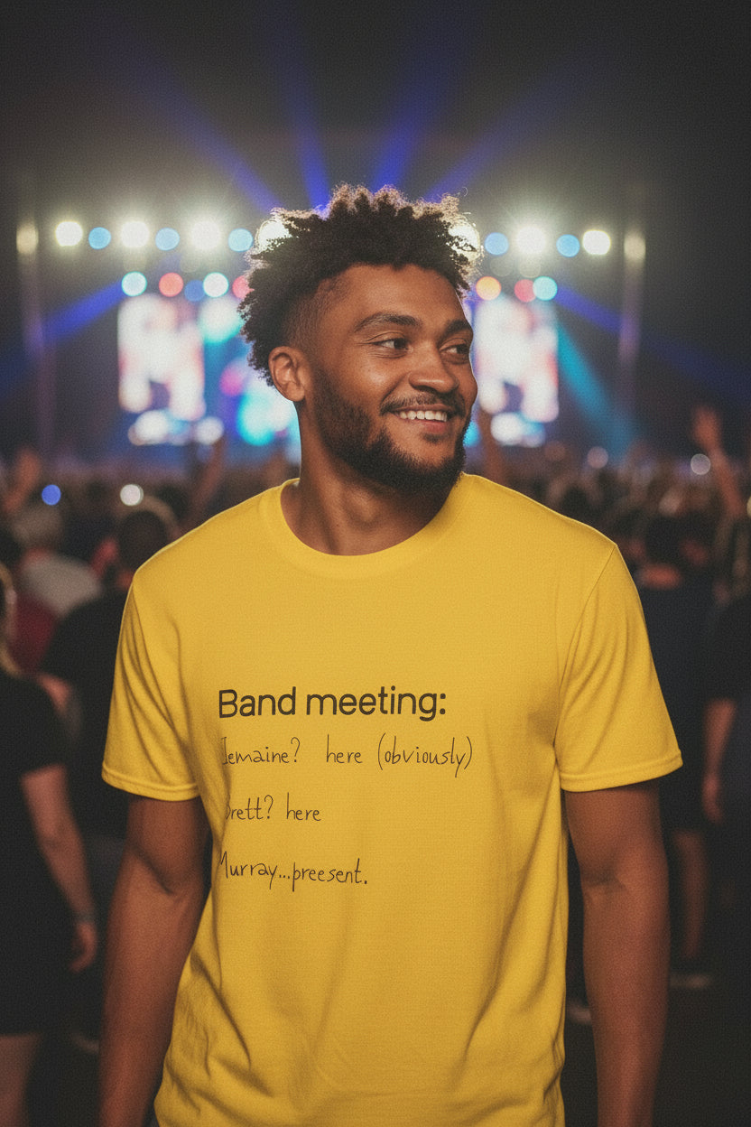 Man wearing a yellow t-shirt with text, sitting on a white stool against a white background